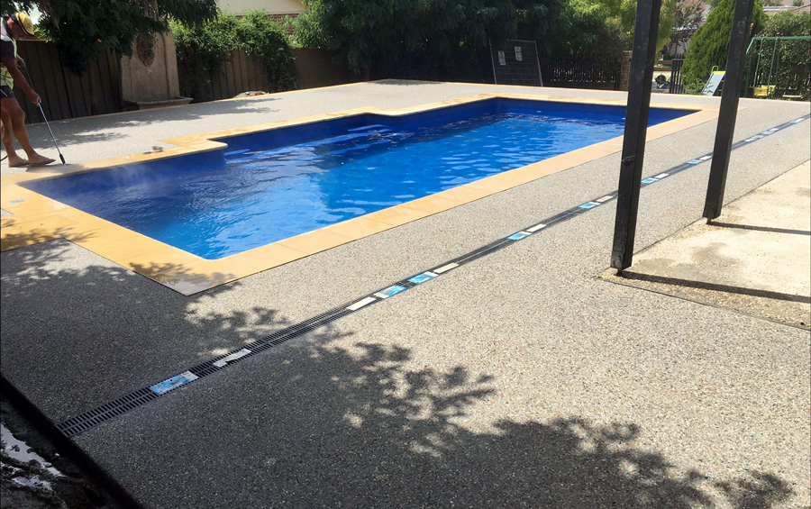 Pool with exposed aggregate surrounds